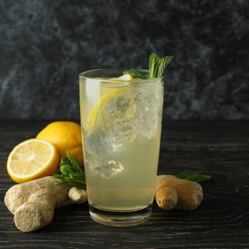 glass-of-ginger-lemon-drink-and-ingredients-on-wooden-table.jpg